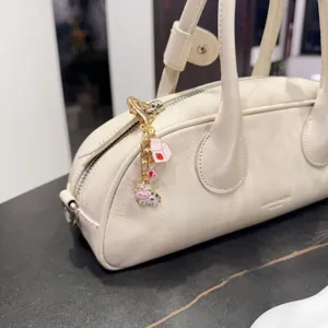 Cream white leather handbag with cute cartoon cow pendant, stylish women shoulder bag daily use