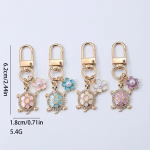 Metal turtle keychain with flower and pearl charms, cute bag pendant and keyring accessory.