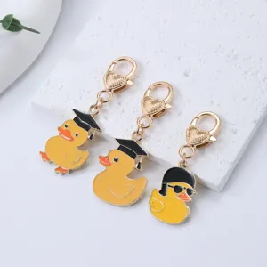 Cartoon little yellow duck metal keychain, cute graduate duck bag pendant and car keyring gift.
