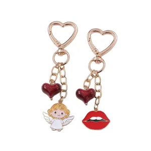 Cute heart-shaped keychain with angel and red lips pendants, ideal bag charm accessory.