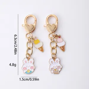 Cute cartoon rabbit and ice cream keychain, metal alloy gold keyring, stylish accessory.