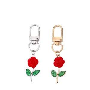 Alloy rose flower keychain with red plush flower and green leaf pendant for bag charm accessory.