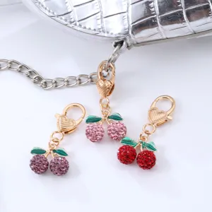 Sparkling rhinestone cherry keychain bag charm with heart clasp for women and car keys.