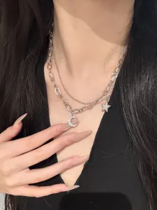 Delicate double-layer silver star and moon necklace with shimmering crystal pendants.