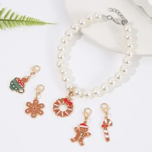 Christmas pearl bracelet with interchangeable holiday alloy charms like gingerbread man and wreath.