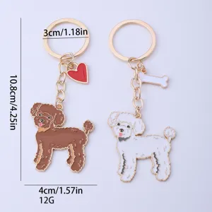 Cute metal poodle keychain with heart and bone charms, stylish bag pendant accessory.