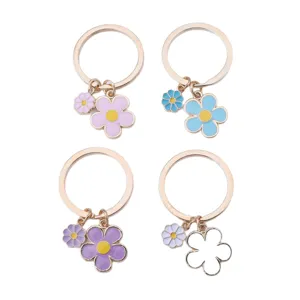 Cute floral enamel keychain set featuring double-sided colorful flower pendants on gold rings.