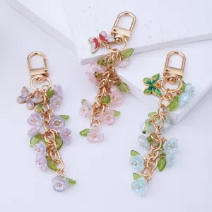 Exquisite metal flower butterfly keychain and chic bag pendant detail showcasing fresh style.