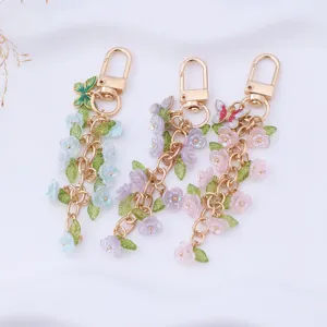 Detailed shot of exquisite floral keychain pendants with golden chains and butterflies.