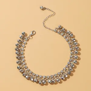 Detailed close-up shot of a silver rhinestone bell anklet, perfect for beach and daily wear.