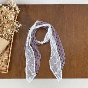 Detail view of the elegant purple lace patchwork scarf with chic pearl buckle accessory.