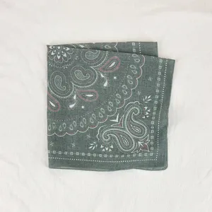 Detailed view of a dark green paisley square scarf, soft breathable fabric for elegant women's wear.