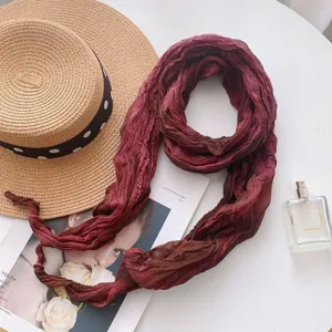 Detailed view of the stylish tie-dye gradient scarf in wine red, perfect for cozy styling.