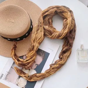 Gradient tie-dye scarf detail, brown crinkle neck scarf styled with hat and magazine flat lay.