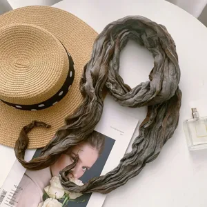 Close-up detail of the stylish gradient tie-dye crinkled scarf displayed nicely on table.