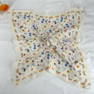 Close-up detail of the retro floral and rainbow print small square scarf texture and pattern.