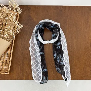 Black paisley skinny scarf with white lace trim and pearl buckle, elegant vintage neck accessory.