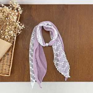 Detailed view of the purple polka dot scarf spliced with delicate white floral lace.