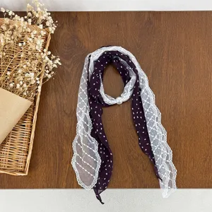Elegant dark purple polka dot scarf with white lace trim and pearl buckle, detailed view.