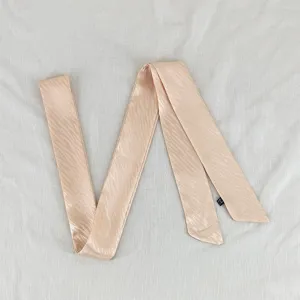 Detailed view of pink satin wave ribbon, ideal as a chic hair scarf or stylish bag accessory.