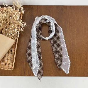 Brown plaid ribbon scarf with delicate white lace trim and elegant pearl accent detail.