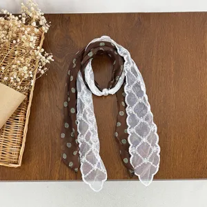 Vintage polka dot silk scarf with delicate white lace stitching and elegant pearl buckle.