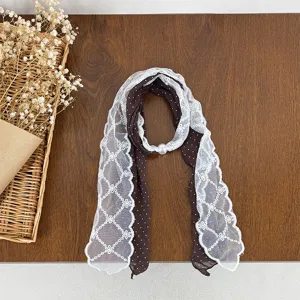 Detailed view of women's retro polka dot lace patchwork scarf with elegant pearl buckle accent.