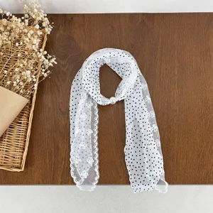 Detail shot of the white lace polka dot scarf with pearl buckle, beautiful retro design.