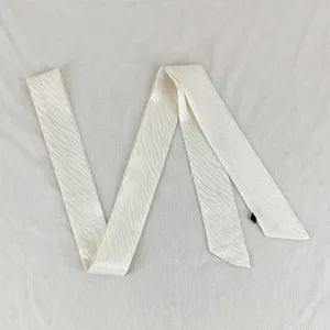 Detailed view of the elegant slim wave ribbon scarf, perfect for versatile styling accessories.
