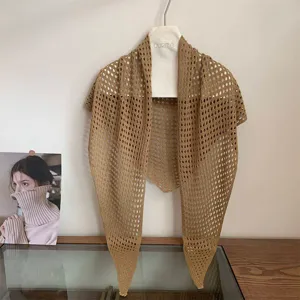 Detailed view of the khaki hollow knit triangular shawl, perfect summer air-conditioning cover.