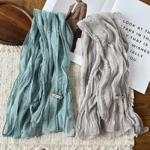 Close-up detail of the crinkled chiffon scarf texture, elegant fabric drape for spring styling.