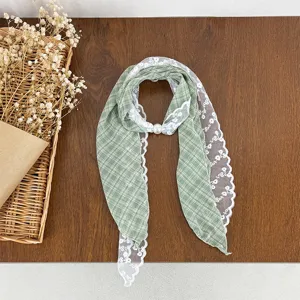 Green plaid lace patchwork scarf with pearl buckle, vintage literary style neck accessory detail.