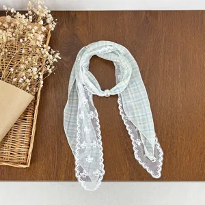Delicate lace patchwork plaid scarf detail with pearl accent for vintage daily styling.