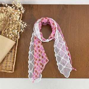 Chic floral print silk scarf featuring delicate white lace trim and an elegant pearl buckle design.