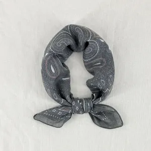 Close-up detail shot of grey paisley pattern small square scarf, soft and breathable texture.