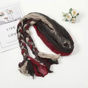 Detailed view of fashionable braided crinkled scarf with multi-color splicing design.