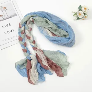 Detailed view of the multi-color braided pleated headscarf and sun protection travel scarf.
