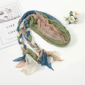 Detail view of the colorful braided crinkled scarf, showcasing texture and styling scene.