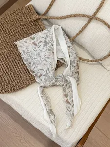 Close-up of vintage floral triangle scarf, soft breathable fabric, lifestyle detail shot.