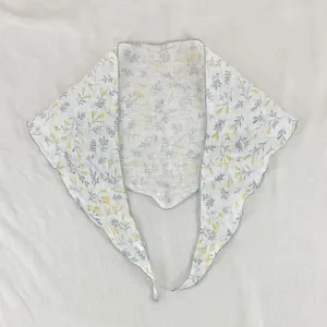 Foulard triangulaire à imprimé floral délicat, accessoire léger élégant pour femme.