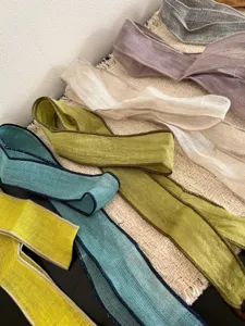 Detailed view of long fabric ribbon scarf, versatile pastel colors, bohemian style accessory.