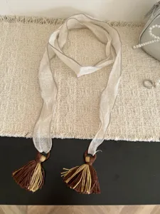 Detailed shot of forest style thin fabric ribbon scarf with vintage multi-color tassels