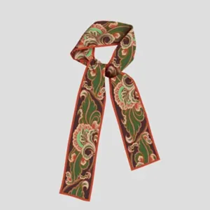 Detailed view of narrow retro floral silk scarf close-up pattern texture and vibrant colors.