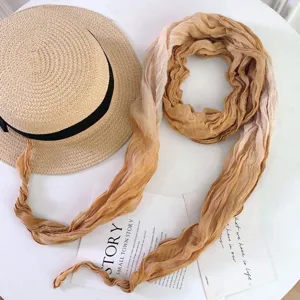 Gradient tie-dye scarf detail showcasing soft fabric texture and elegant draped style.