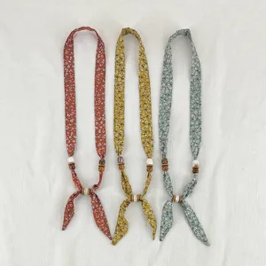 Vintage floral fabric scarf necklace with wooden beads, elegant necktie accessory for women.