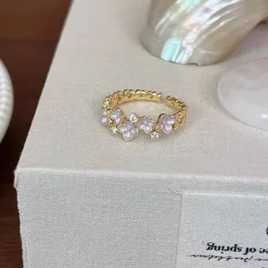 Gold vintage open ring for women featuring delicate purple enamel flowers and sparkling cubic zirconia.