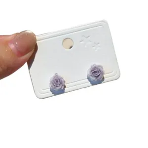 Elegant light purple rose flower stud earrings with silver needles on white display card.