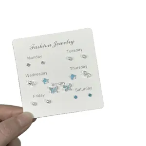 Cute weekly set of earrings featuring butterfly, bow, star, and pearl designs in silver tone.
