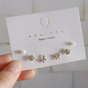 Minimalist stud earrings set featuring delicate pearls, roses, and butterflies for daily wear.