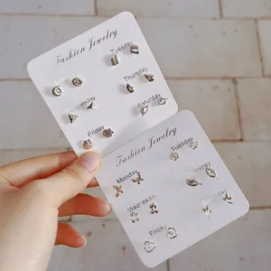 Minimalist silver stud earrings set featuring geometric, butterfly and flower designs.